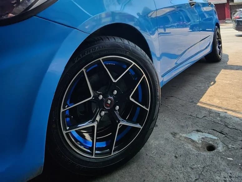 Blue hatchback on black and blue concave mags