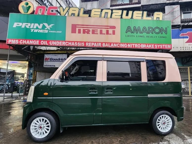 Green Suzuki van in front of the NC Valenzuela storefront signage