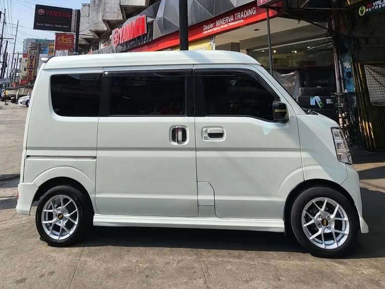 White Suzuki van on silver mags outside the shop