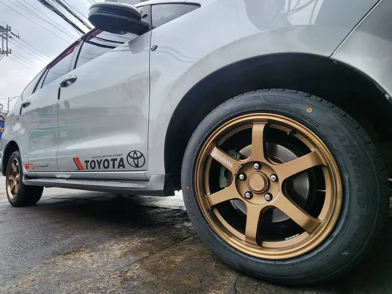 Silver Toyota on bronze six-spoke mags