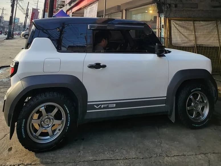 White VinFast VF3 on chrome mags